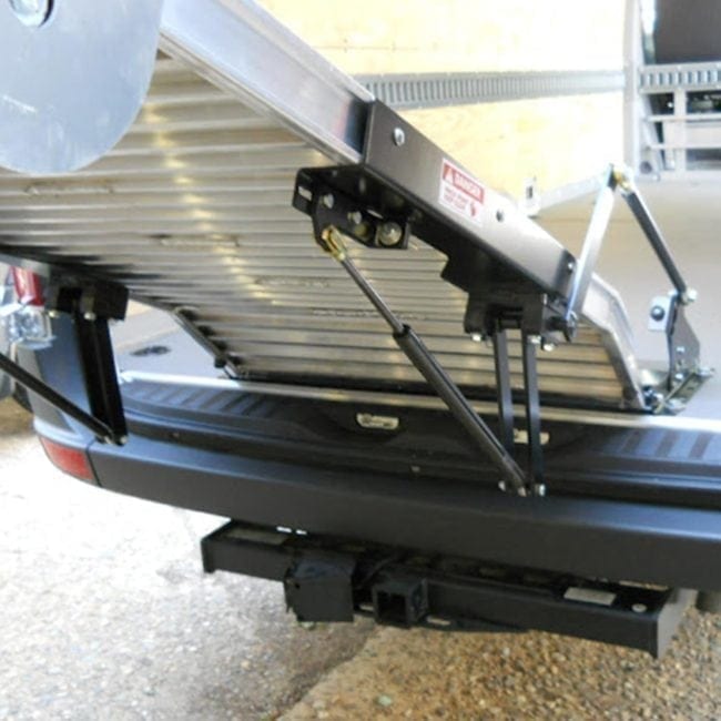 Link spring assist option shown installed on a work truck ramp.