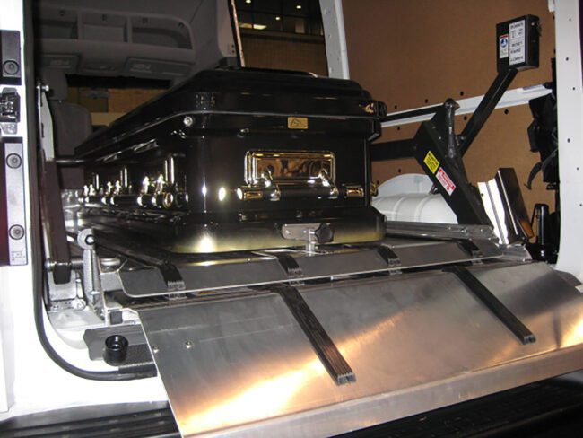View of a Link brand DD2000-XLC installed in the back of a van holding a casket.
