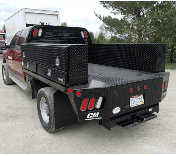 Contractor series gloss black diamond tread toolbox shown mounted on the side of a service body truck.