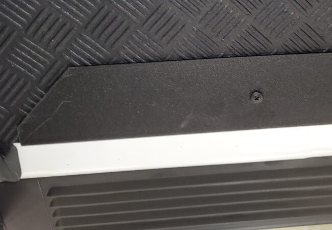 Close up view of black textured sill installed in the van.